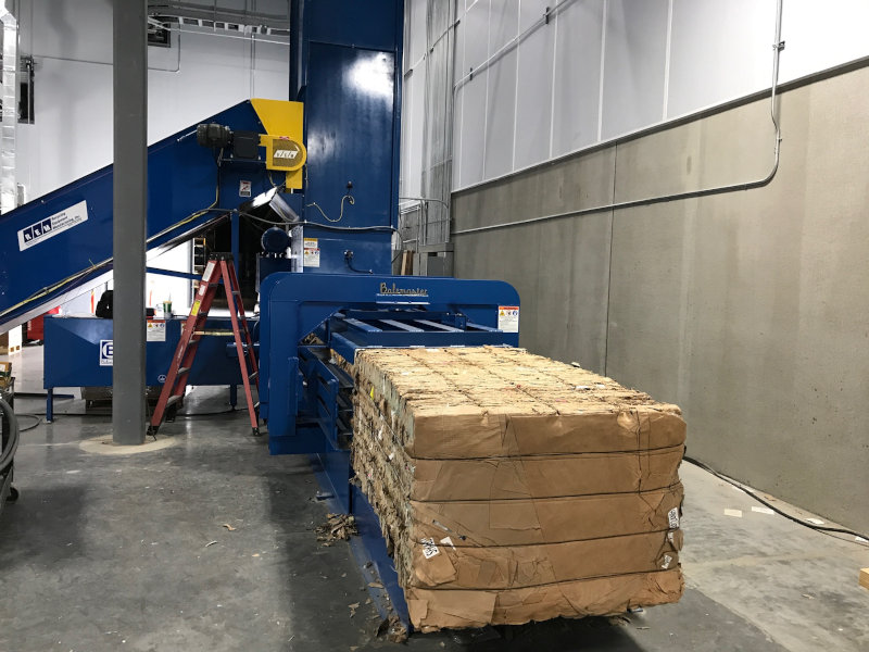 A relevant stock photo of baler machine in a typical setting.