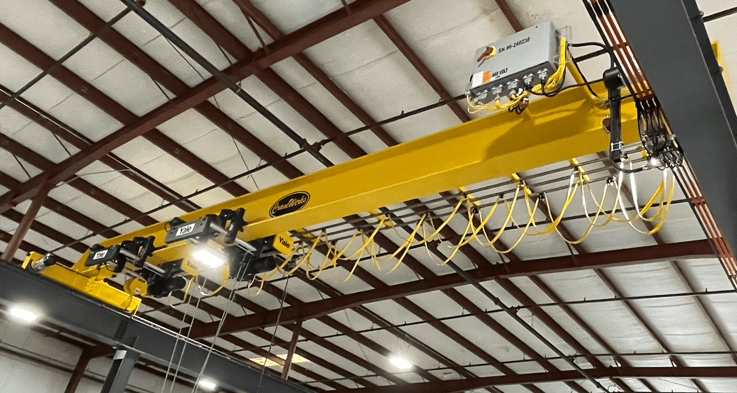 A relevant stock photo of bridge crane in a typical setting.