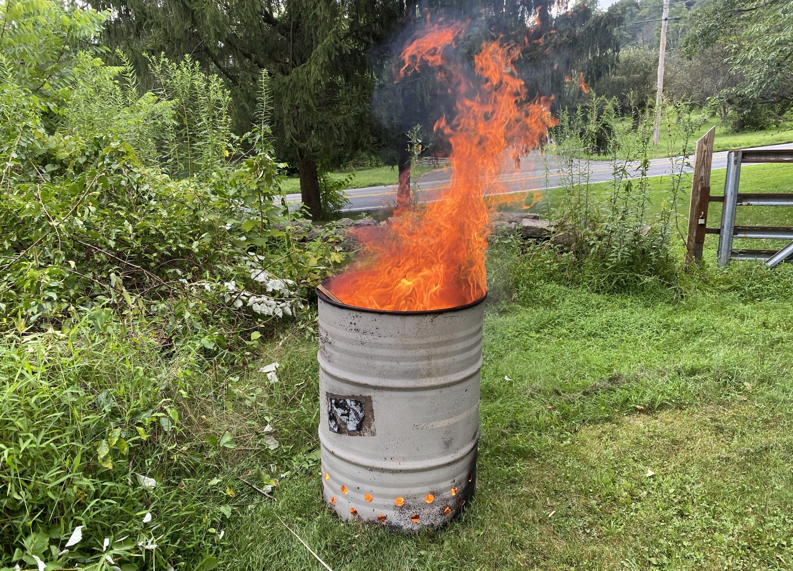 A relevant stock photo of burn barrel in a typical setting.