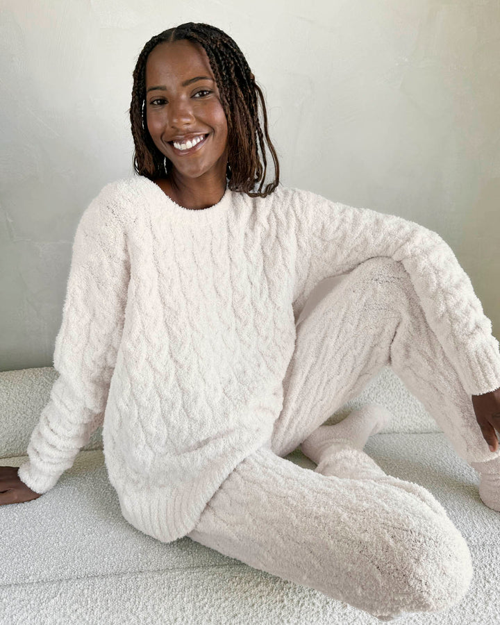 A relevant stock photo of cable knit sweater in a typical setting.