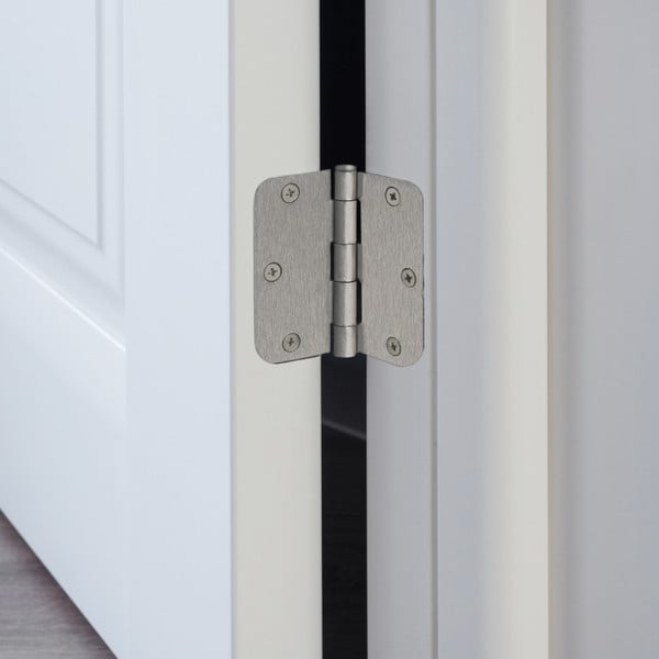 A relevant stock photo of door hinges in a typical setting.