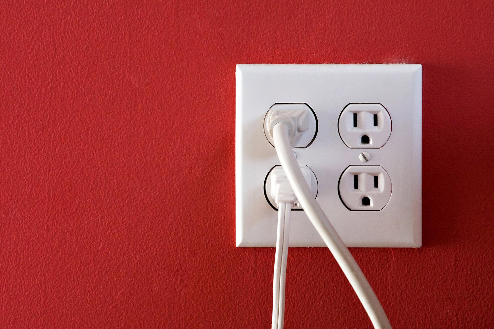 A relevant stock photo of electrical plugs and outlets in a typical setting.