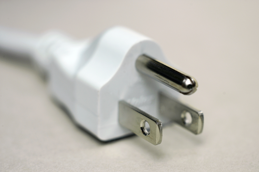 A relevant stock photo of electrical prongs in a typical setting.