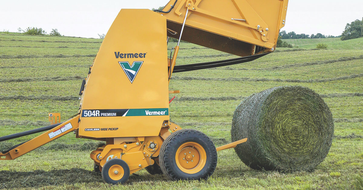 A relevant stock photo of hay balers in a typical setting.