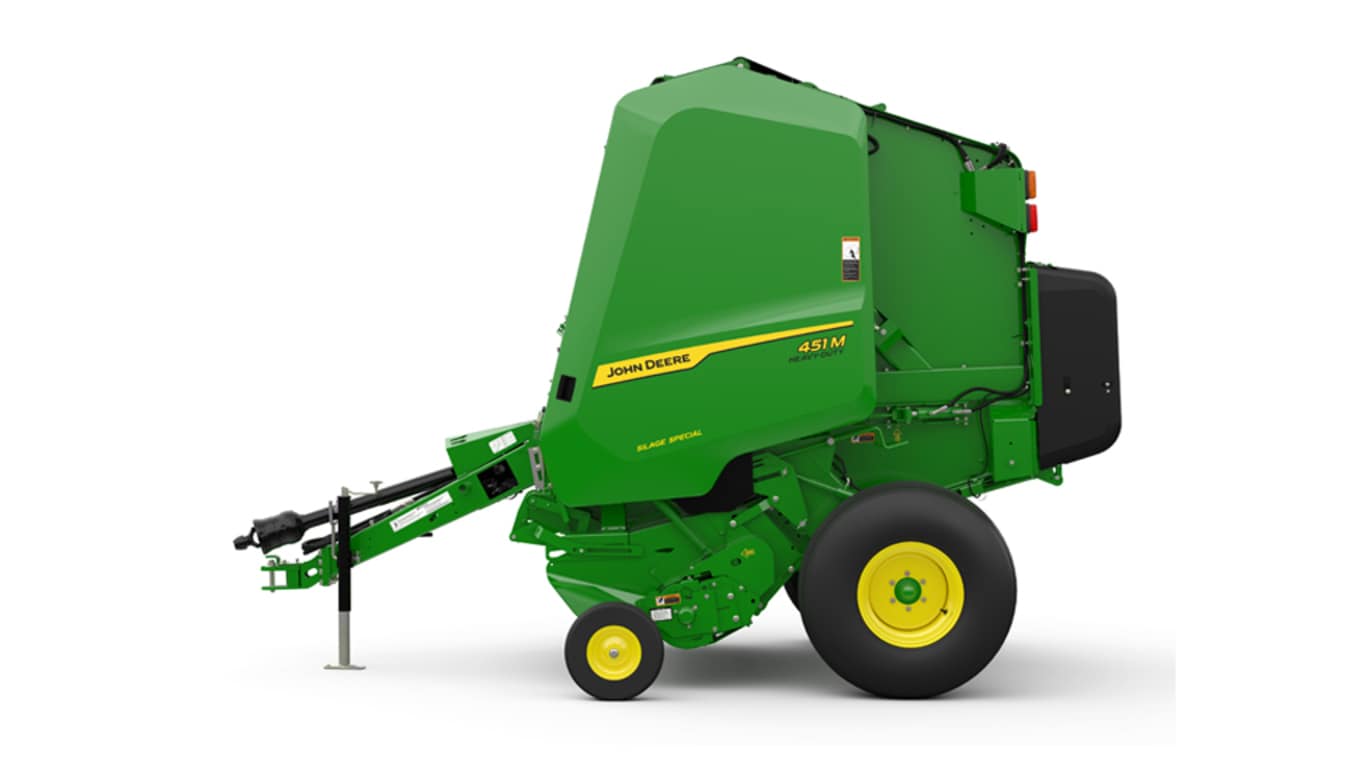 A relevant stock photo of hay balers in a typical setting.