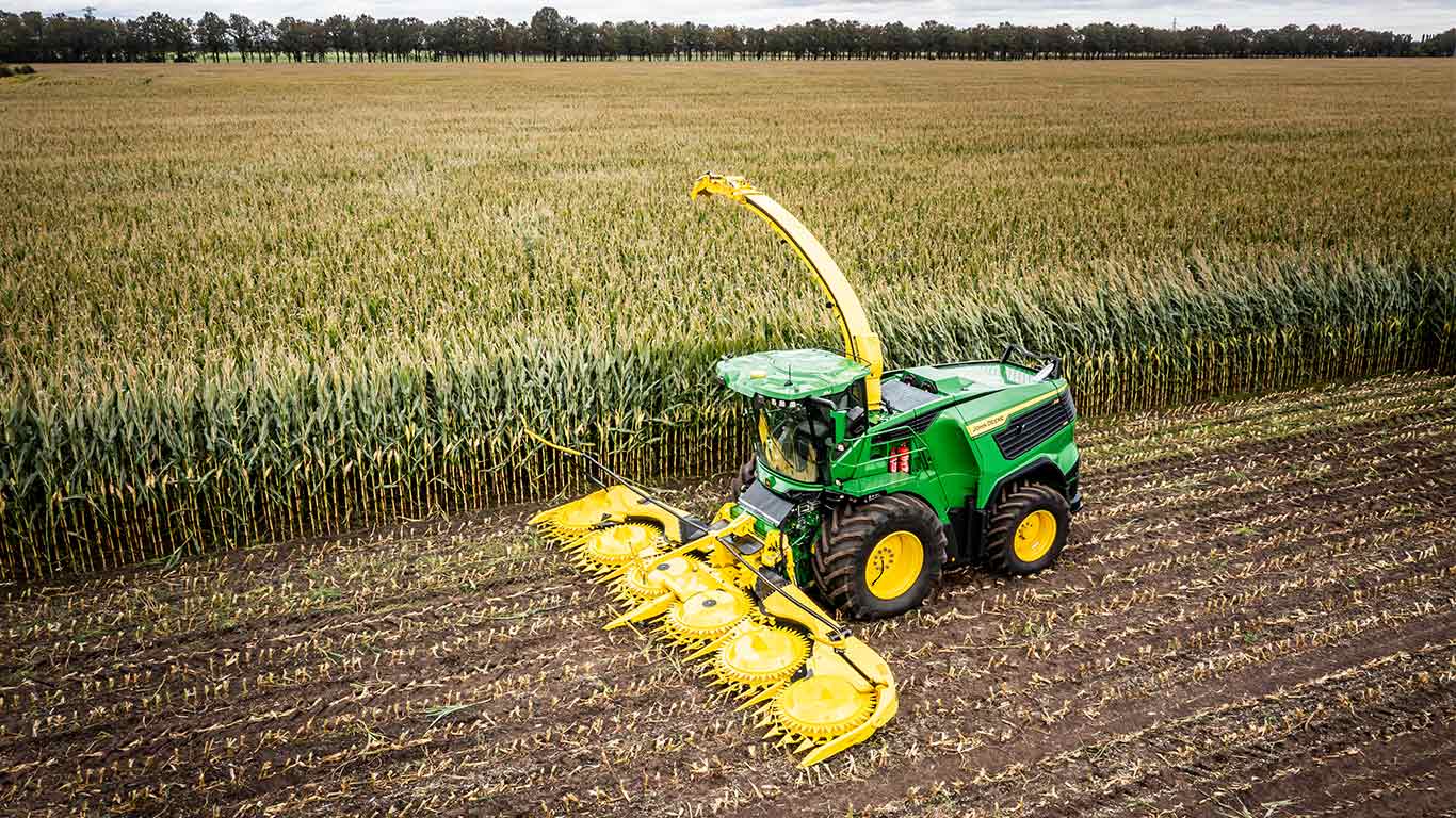 A relevant stock photo of hay balers in a typical setting.