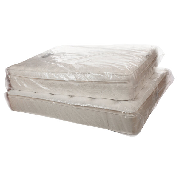 A relevant stock photo of mattress in a bag in a typical setting.