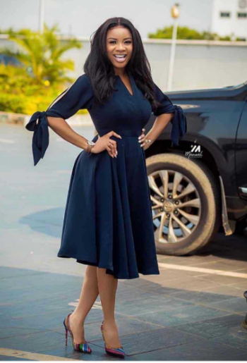 A relevant stock photo of navy blue dress in a typical setting.
