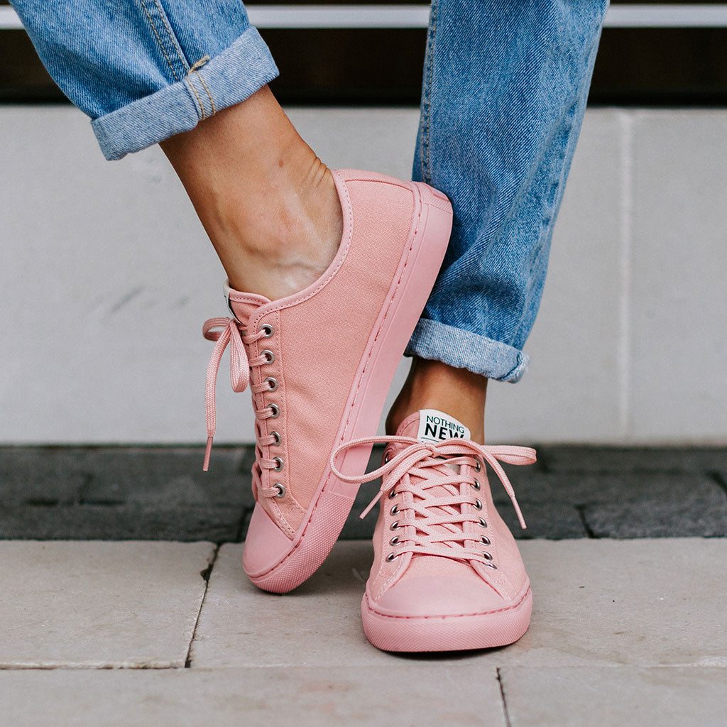 A relevant stock photo of pink sneakers in a typical setting.