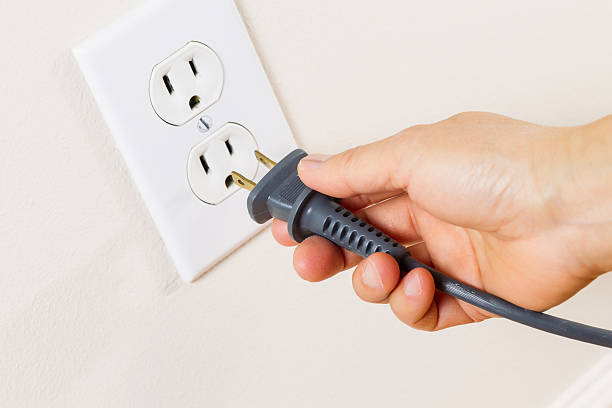 A relevant stock photo of plugging electrical in a typical setting.