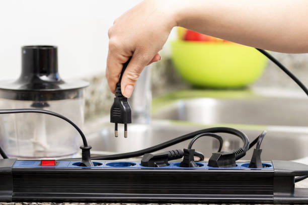 A relevant stock photo of plugging electrical in a typical setting.