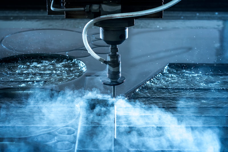 A relevant stock photo of water jet cutter in a typical setting.